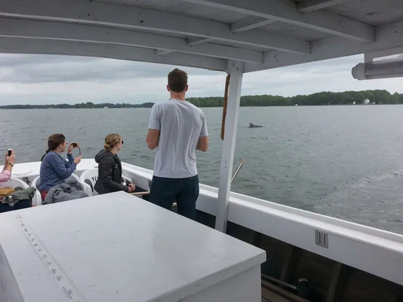 Passengers watching the water from the deck of the Helen Elizabeth